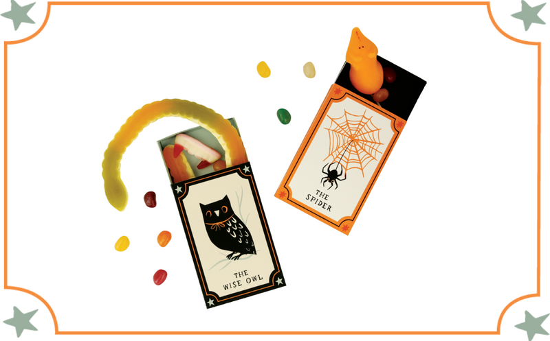 Halloween matchbox craft with Wise Owl and Spider cards, plus a yellow gummy worm and scattered candies.