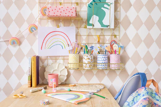 Colorful craft desk with pencil toppers, a rainbow drawing, and back to school supplies.