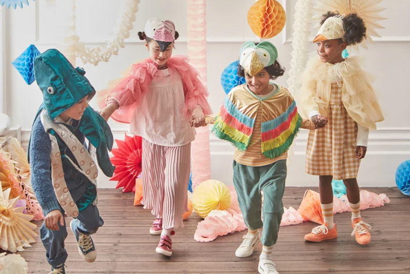 Children in whimsical costumes holding hands