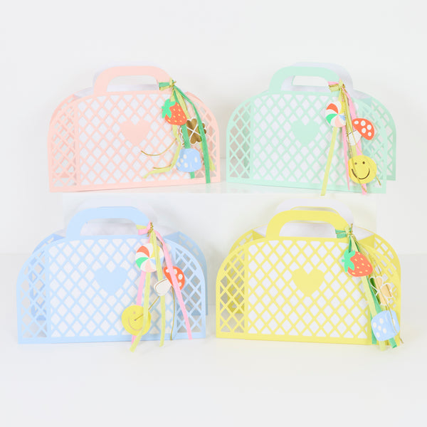 Our party favour bags are designed to look like little baskets, in pink, blue, mint and yellow, complete with paper charms tied on with ribbons. Image3