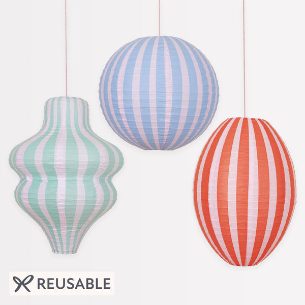 Decorate a room with our striped lanterns, crafted from paper with a pink cord for hanging. Image1