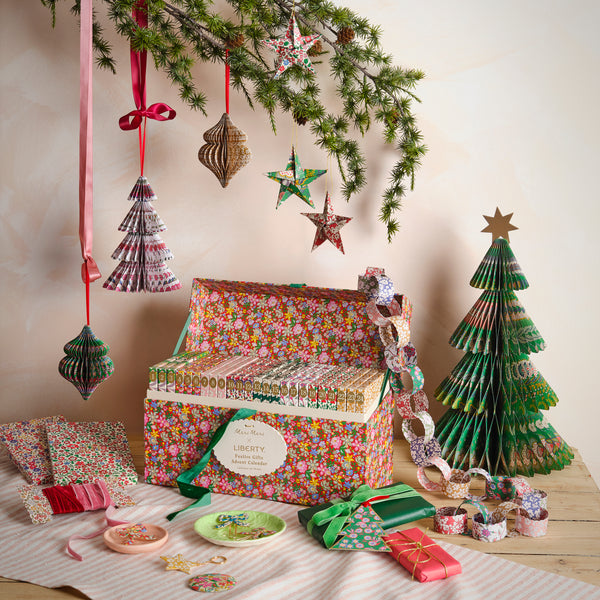 Our advent calendar is beautifully presented in a large Liberty print design box with 24 boxes inside containing stationery and decorations. Image1