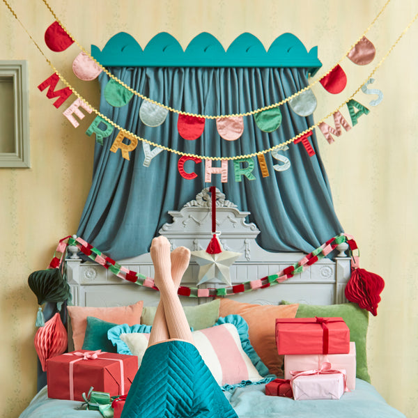 Our Merry Christmas garland is made in velvet with a mix of traditional and modern colours and metallic gold ric rac. Image2