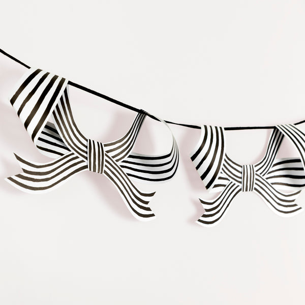Our paper garland is perfect to add to your Halloween hanging decorations, with black and striped bows it's eerily stylish. Image3