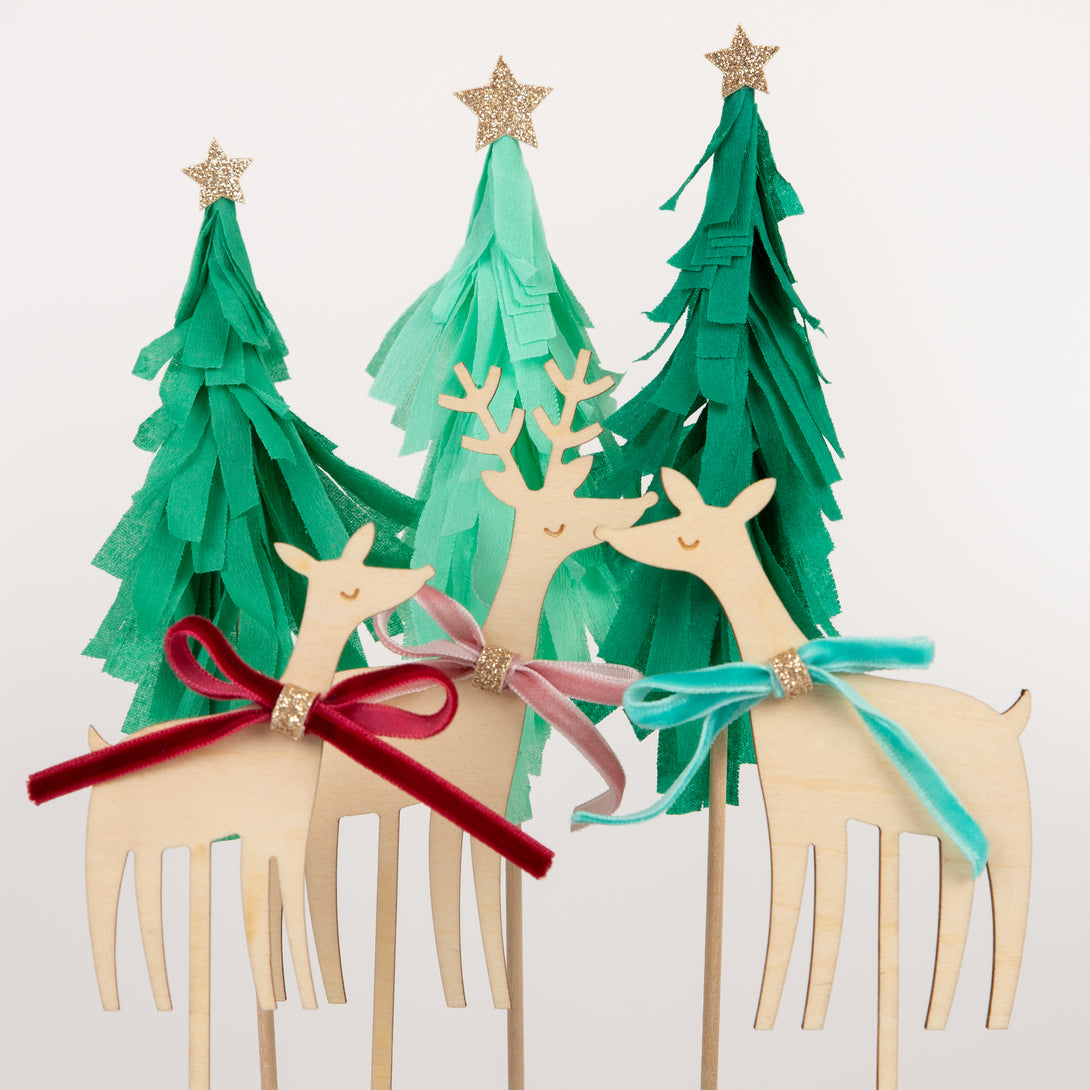 Our Christmas cake toppers, with wooden reindeer and paper Christmas trees will make your festive cakes look amazing.