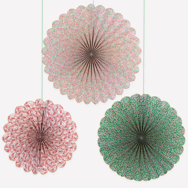 Our Christmas hanging decorations set features 3 paper Liberty floral print pinwheels with velvet hanging ribbons, perfect for an elegant look. Image1