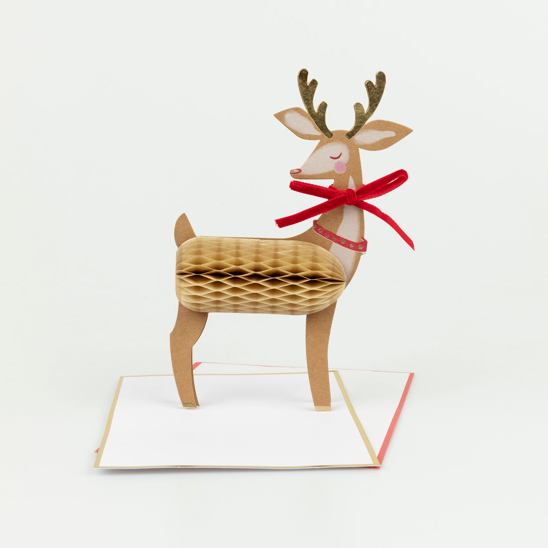 Our reindeer Christmas card stands up to give a wonderful decoration, and features honeycomb paper, a luxe velvet bow and shiny gold foil. Image1