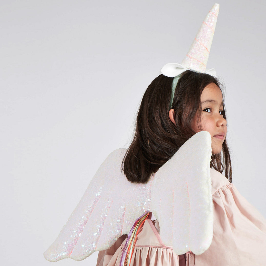 The glittery wings and unicorn headdress are crafted from pink iridescent glitter sequin fabric, with ribbon tassles.