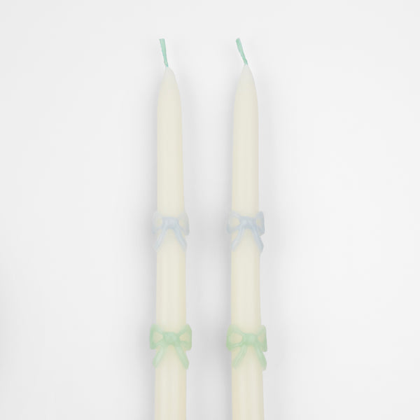 Our party candles, crafted in a tapered shape with embossed and handpainted pastel bows, have mint green wicks. Image3