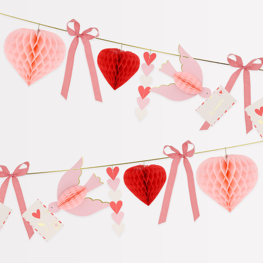 Our Valentine's decoration is a beautiful Valentine's garland with 3D hearts, love birds and gingham bows, all in pretty pink and red tones. Image1