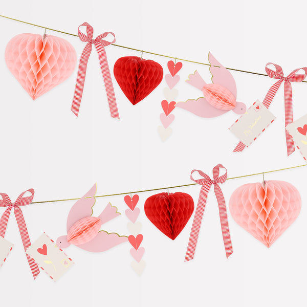 Our Valentine's decoration is a beautiful Valentine's garland with 3D hearts, love birds and gingham bows, all in pretty pink and red tones. Image1