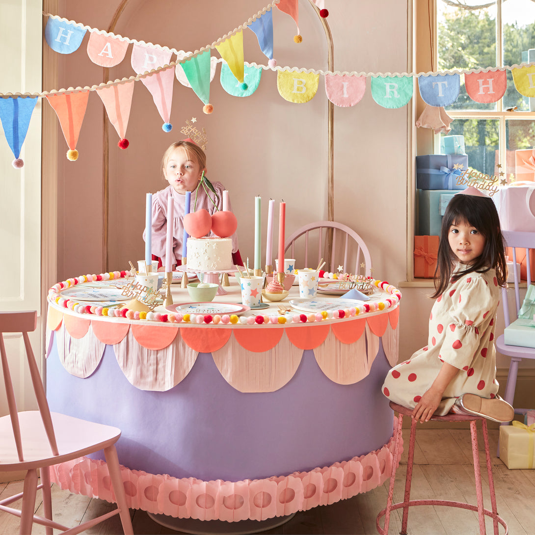 Add a pop of pastel colour to your party table or wall with our flag garland with pompoms.