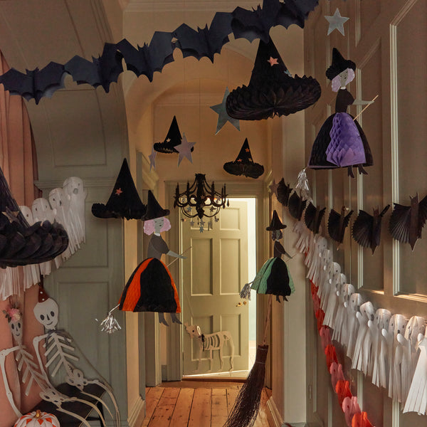 Our Halloween hanging decorations feature happy witches with honeycomb details, and shiny silver stars and a moon. Image2