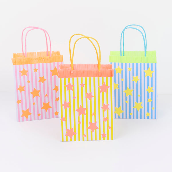 Our party paper bags feature stripes, stars and fringed details  in blue, pink and yellow, for a fun look, perfect for birthdays and fun celebrations. Image2