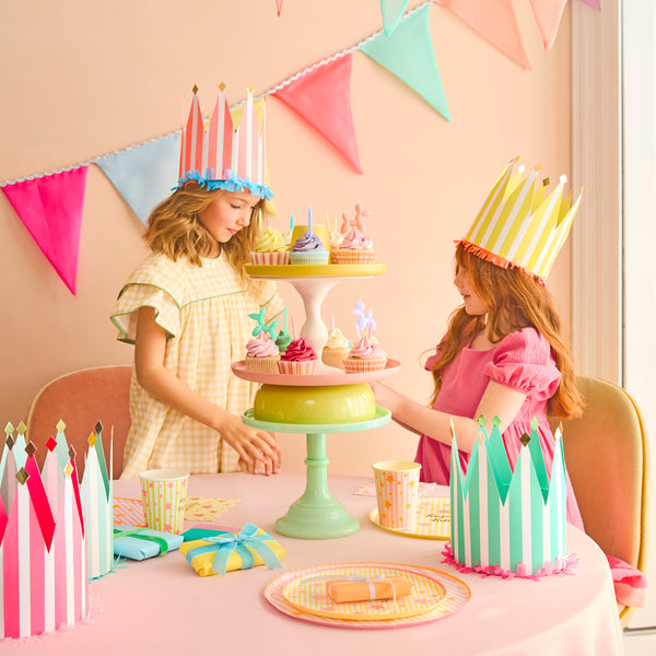 Our paper crowns, made with vibrant stripes, tissue paper fringing and shiny gold foil details, are the perfect birthday party hats. Image2
