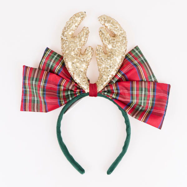 Dress up this Christmas with our fun reindeer antler headband, with gold sequin fabric antlers, a big tartan bow and a velvet headband, so stylish. Image1