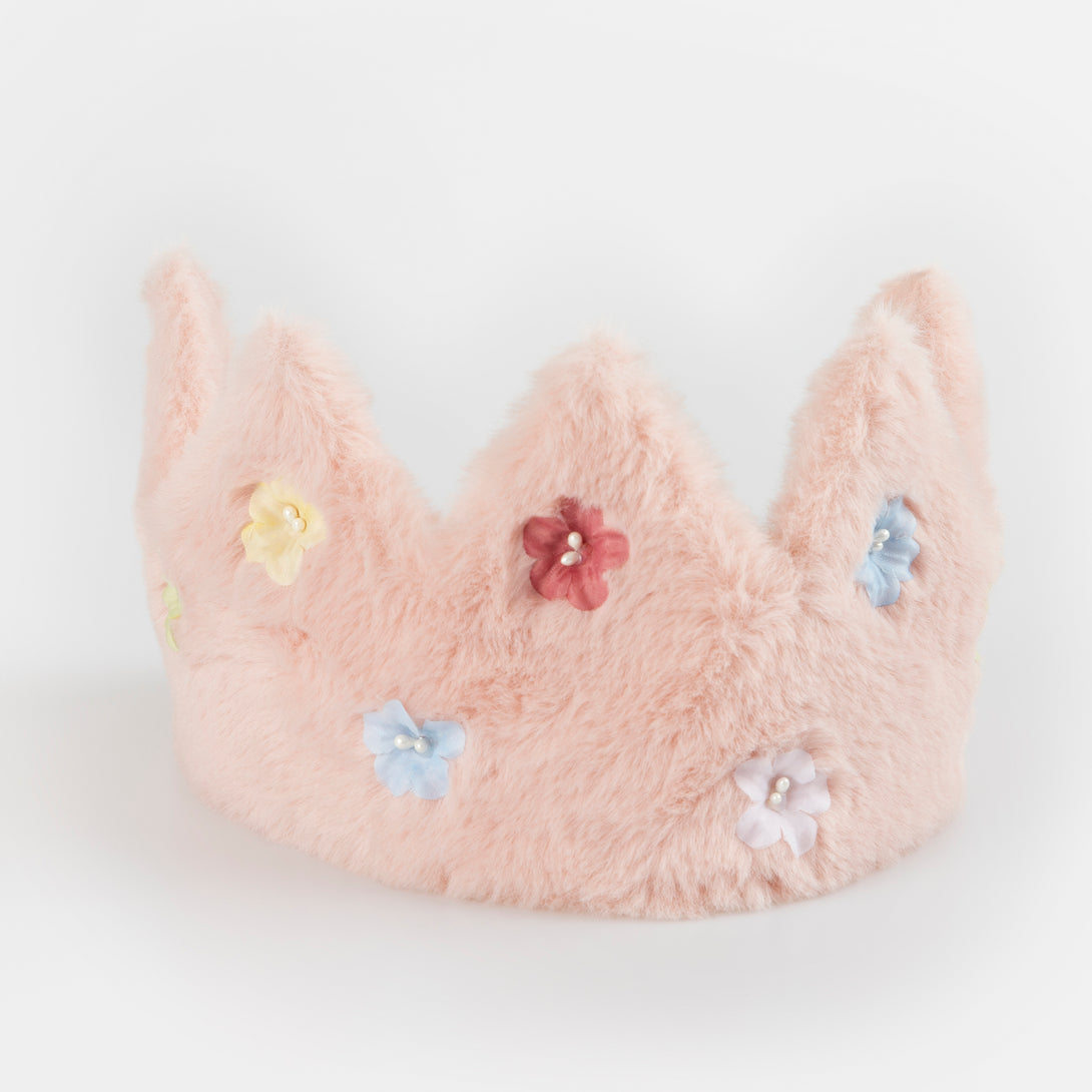 Our pink crown is made from soft fabric and has sparkling flower sequins.