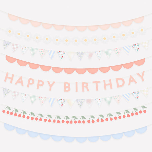 Our pretty birthday garlands, made from paper, feature soft blue, pink and white tones with a birthday message, flowers, cherries and scallops. Image1