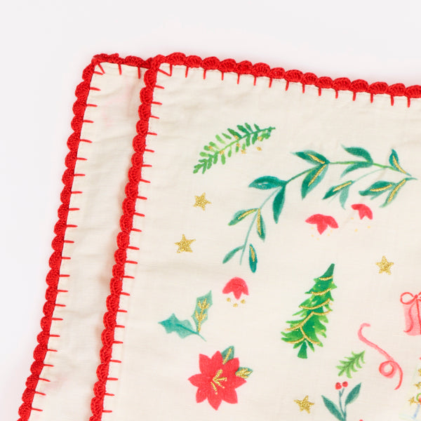 Our Christmas placemats, made from a linen and cotton mix, feature Santa in a folk-inspired scene, with gold embroidery and a crochet trim. Image4