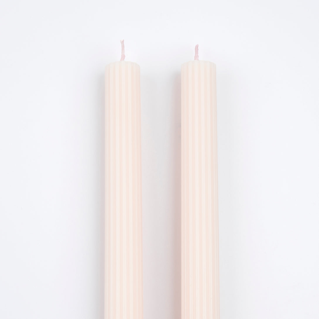 Decorate your table or mantel with our ridged long candles in a pretty peach pink shade.