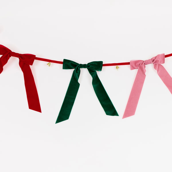 Our Christmas garland features luxurious velvet bows and tinkling bells, hung on a velvet ribbon for an elegant reusable decoration. Image2