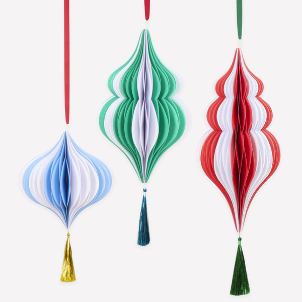 Our hanging Christmas decorations, made from honeycomb, feature vibrant stripes, tinsel tassels and satin ribbons for a statement look. Image1