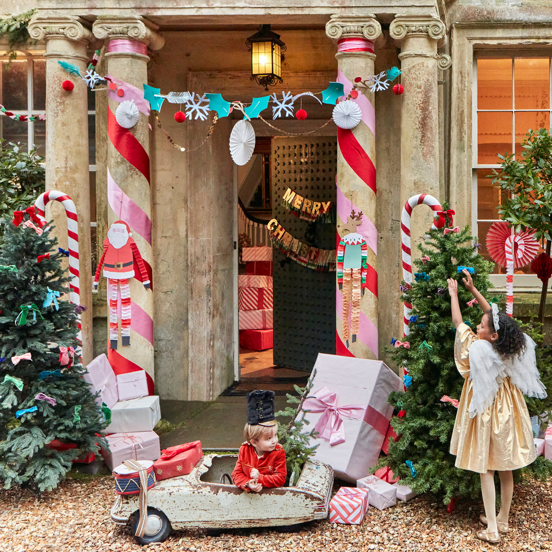 Our Christmas garland includes Christmas foliage with paper holly, berries, snowflakes and honeycomb decorations.