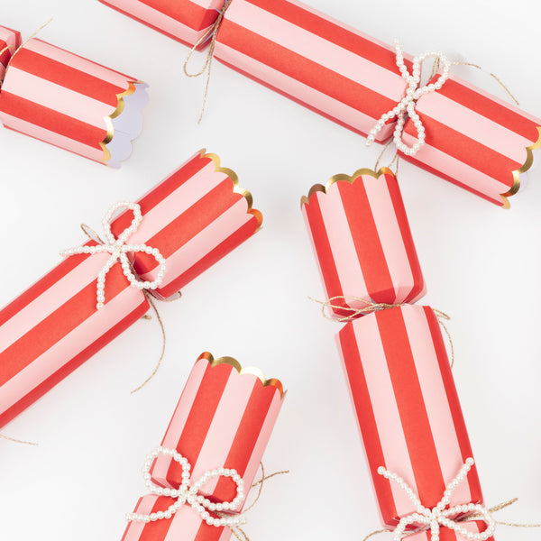Our striped Christmas crackers feature faux pearl bows, which can be used as tree decorations, and contain a paper hat, joke and gift. Image3