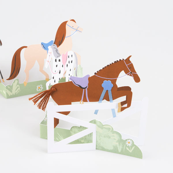 Our horse birthday card features horses, ribbons, tassels and a jump, and makes a great decoration for a horse party. Image3