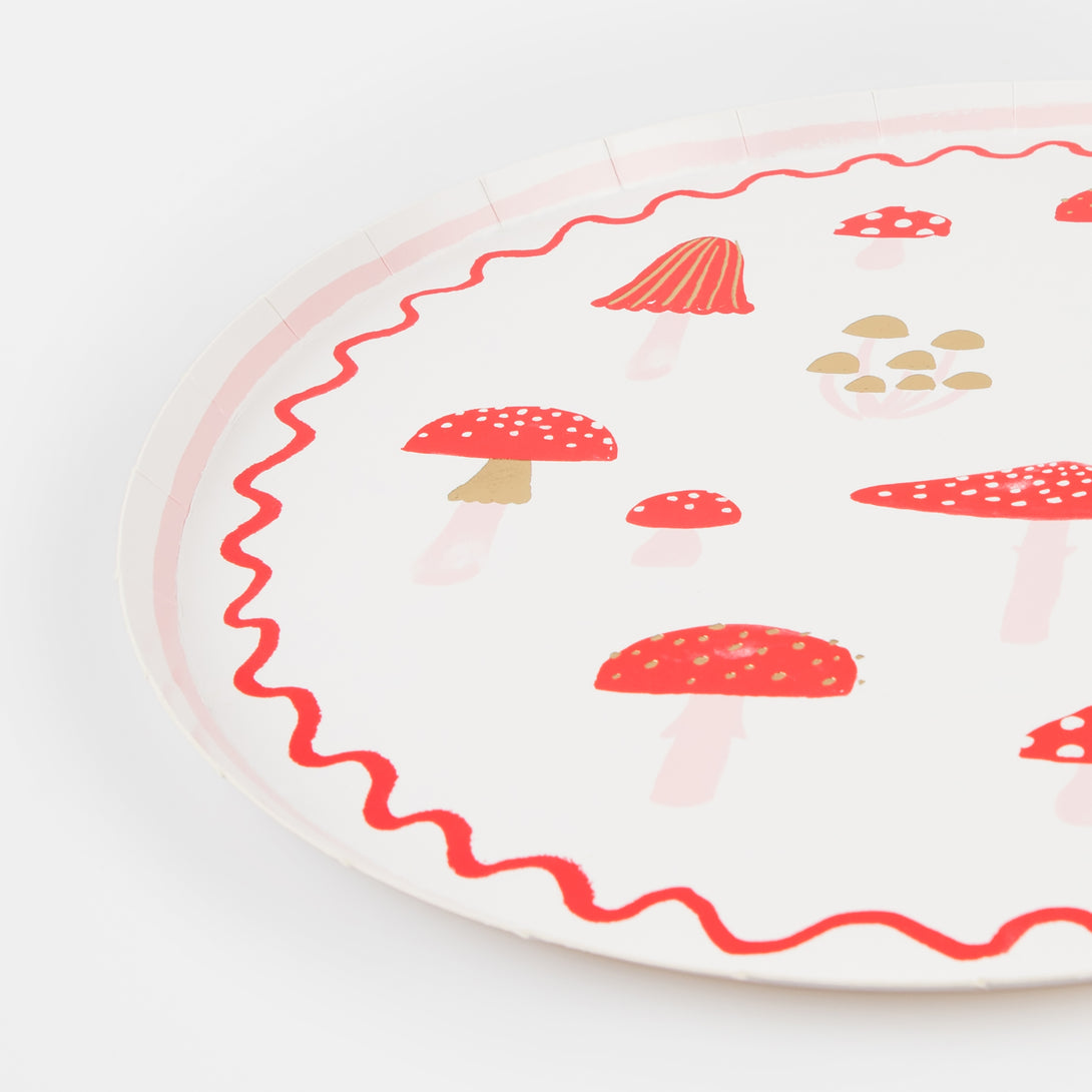 Our Christmas paper plates feature mushroom in festive red and white with stylish modern pink and gold foil details.