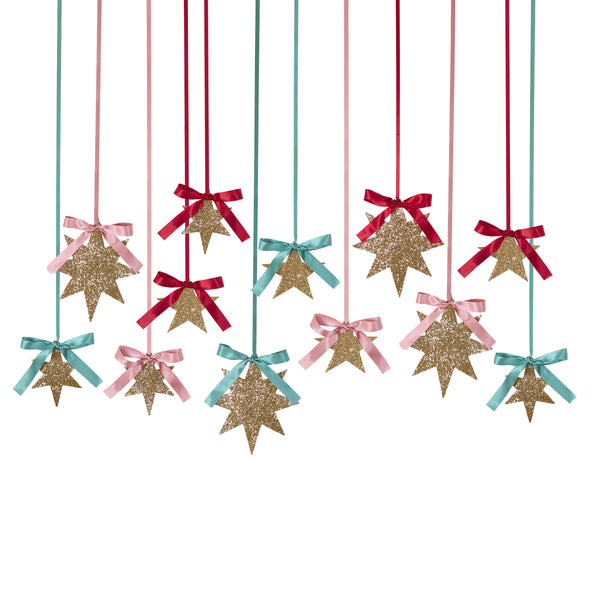 Our Christmas star decorations come in a set of 12, with 3 sizes. Covered with gold glitter, topped with ribbon bows, they are super stylish. Image3