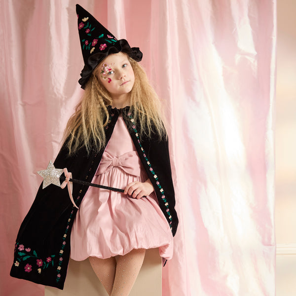 Our witch costume, made from luxurious black velvet with an embroidered floral design, features a cape, hat and a star topped wand. Image1