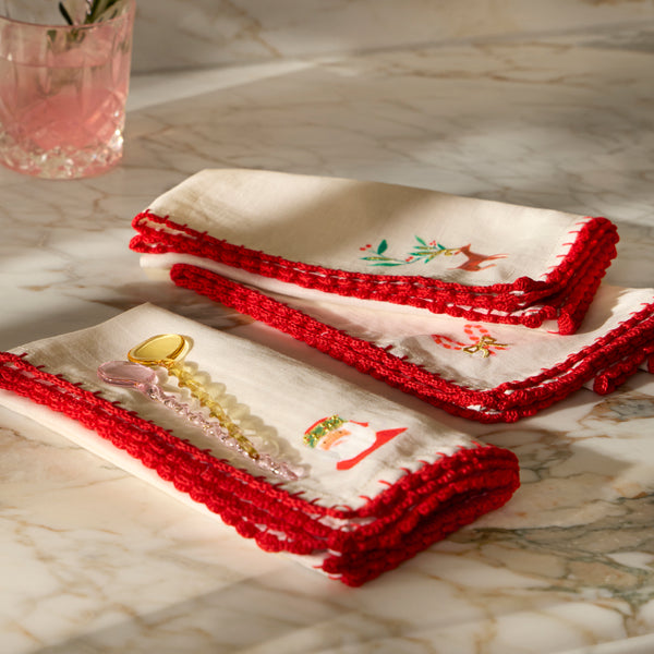 Our Christmas fabric napkins are made from an ivory linen and cotton blend, with festive motifs, embroidered details and crochet borders. Image2