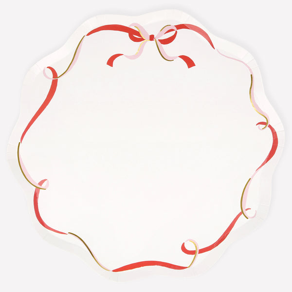 Our paper Christmas dinner plates feature a pink, red and gold modern bow design. Image1