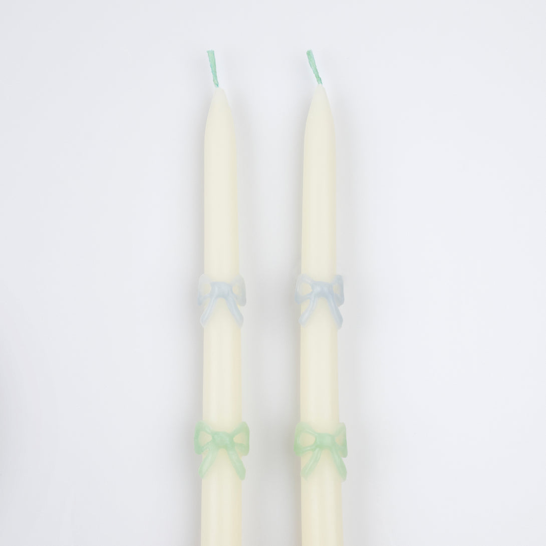 Our party candles, crafted in a tapered shape with embossed and handpainted pastel bows, have mint green wicks.