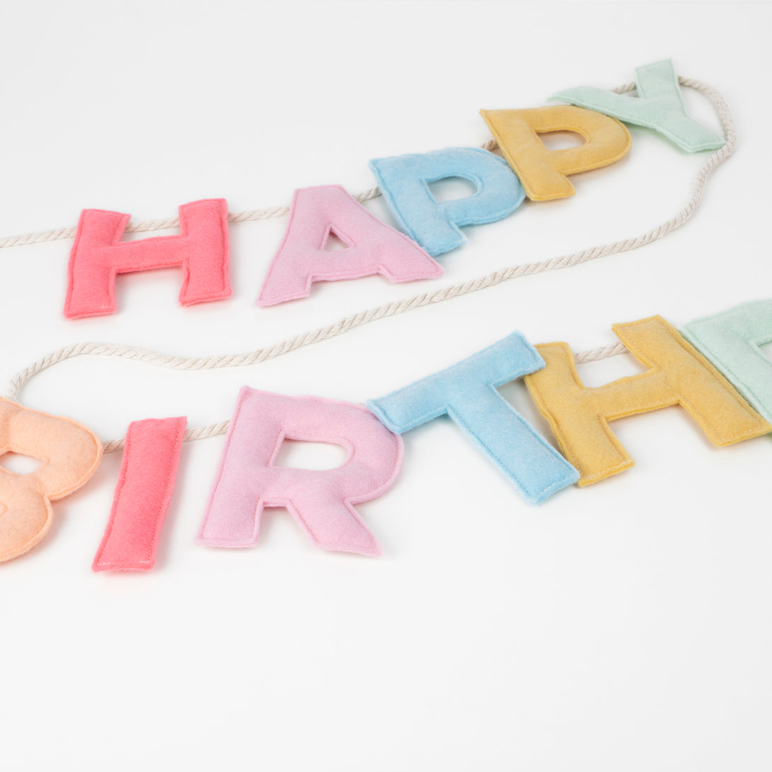 Add a rainbow of colour to your birthday party supplies with a colourful felt garland, paper tablecloth and bright birthday cake candles. 