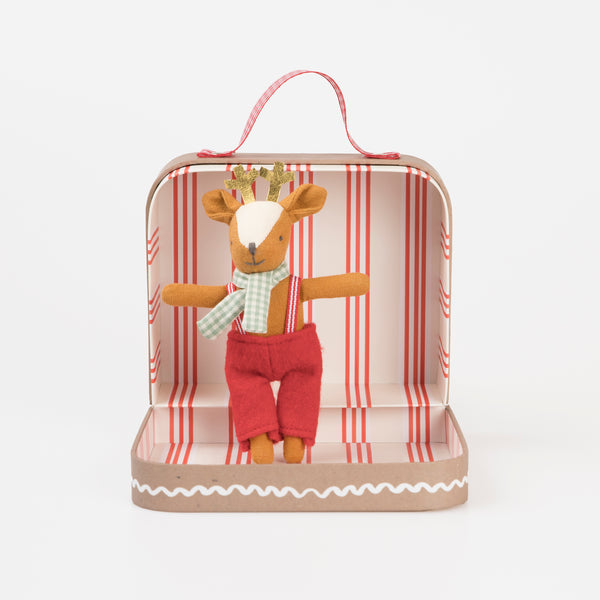 Our Christmas doll set includes a mini fabric reindeer doll in a laminated mini suitcase designed to look like a gingerbread house.