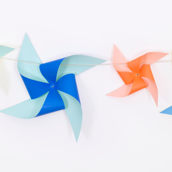 Our paper pinwheel garland is the perfect statement party decoration for a pool party, beach birthday or where you want a summer party vibe. Image3