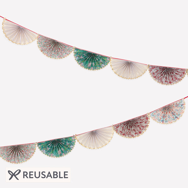 Our elegant Christmas garland has Liberty prints and matt gold foil details, pre-threaded on to a stylish red velvet ribbon. Image1