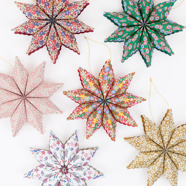 Our star decorations are designed to hang from your Christmas tree, featuring elegant Liberty print designs in rich festive colours. Image1