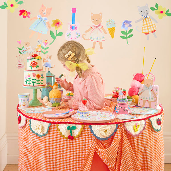 Our special paper gift bags feature adorable kittens in folk-inspired outfits with pretty ribbon bow embellishments, ideal for birthday parties. Image2