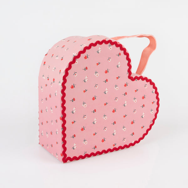 Our kids accessories feature heart suitcases in pink, red and white with soft velvet handles. Image6