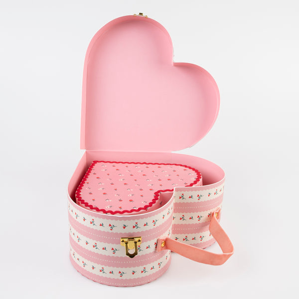 Our kids accessories feature heart suitcases in pink, red and white with soft velvet handles. Image3