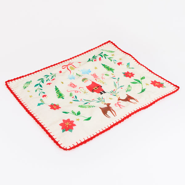 Our Christmas placemats, made from a linen and cotton mix, feature Santa in a folk-inspired scene, with gold embroidery and a crochet trim. Image3