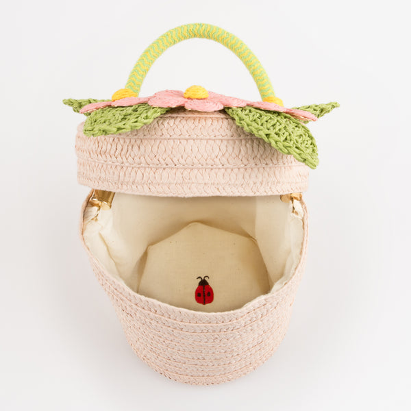 Our woven paper pink basket bag features paper flowers and leaves, a cord handle and a calico lining. Image6