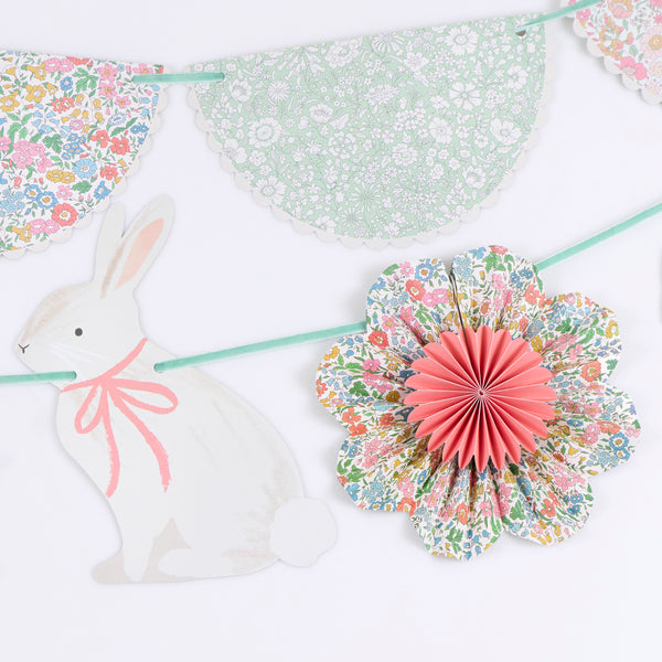 Our Easter decoration set includes 2 paper garlands with Liberty floral design flower pinwheels and scalloped shapes, and Easter bunnies. Image3
