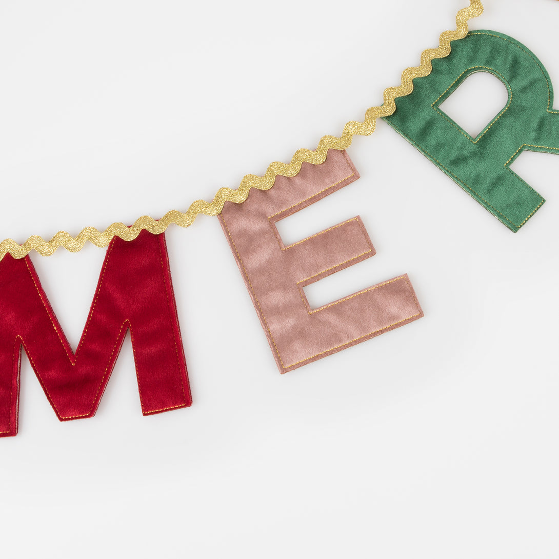 Our Merry Christmas garland is made in velvet with a mix of traditional and modern colours and metallic gold ric rac.