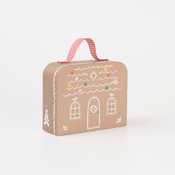 Our Christmas doll set includes a mini fabric reindeer doll in a laminated mini suitcase designed to look like a gingerbread house. Image4