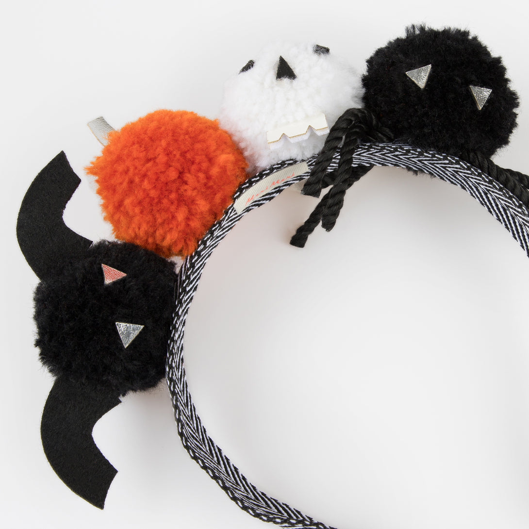 Add our Halloween headband, with fun pom pom details, to your Halloween accessories for a thrilling look.