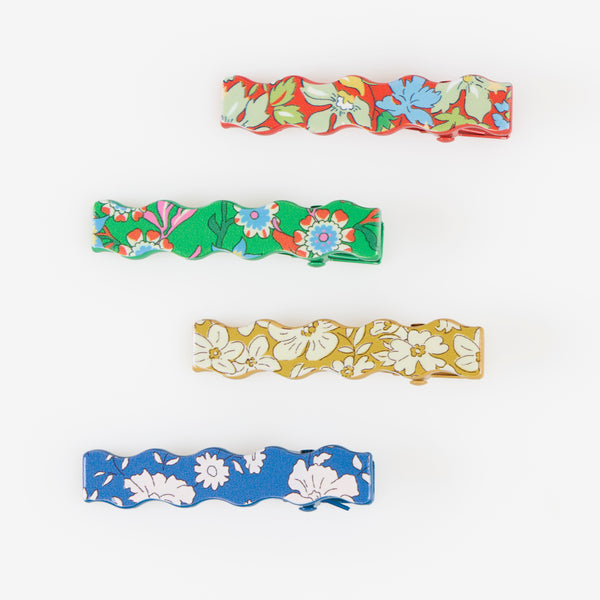 Our Christmas hair clips feature 8 different Liberty floral print designs and an elegant wavy shape, perfect to elevate your festive hair styles. Image3